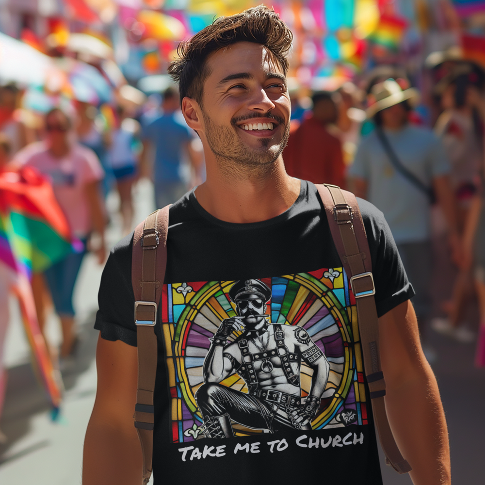 A person wearing a black T-shirt with a graphic design and the text 'TAKE ME TO CHURCH' on it, standing in a colorful outdoor setting.