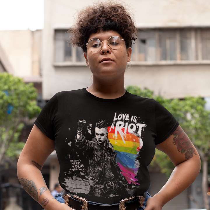 Full-body view of the black graphic tee on a model. Shows the relaxed, gender-neutral retail fit of the shirt, suitable for diverse body types. The white text stands out boldly against the dark fabric.