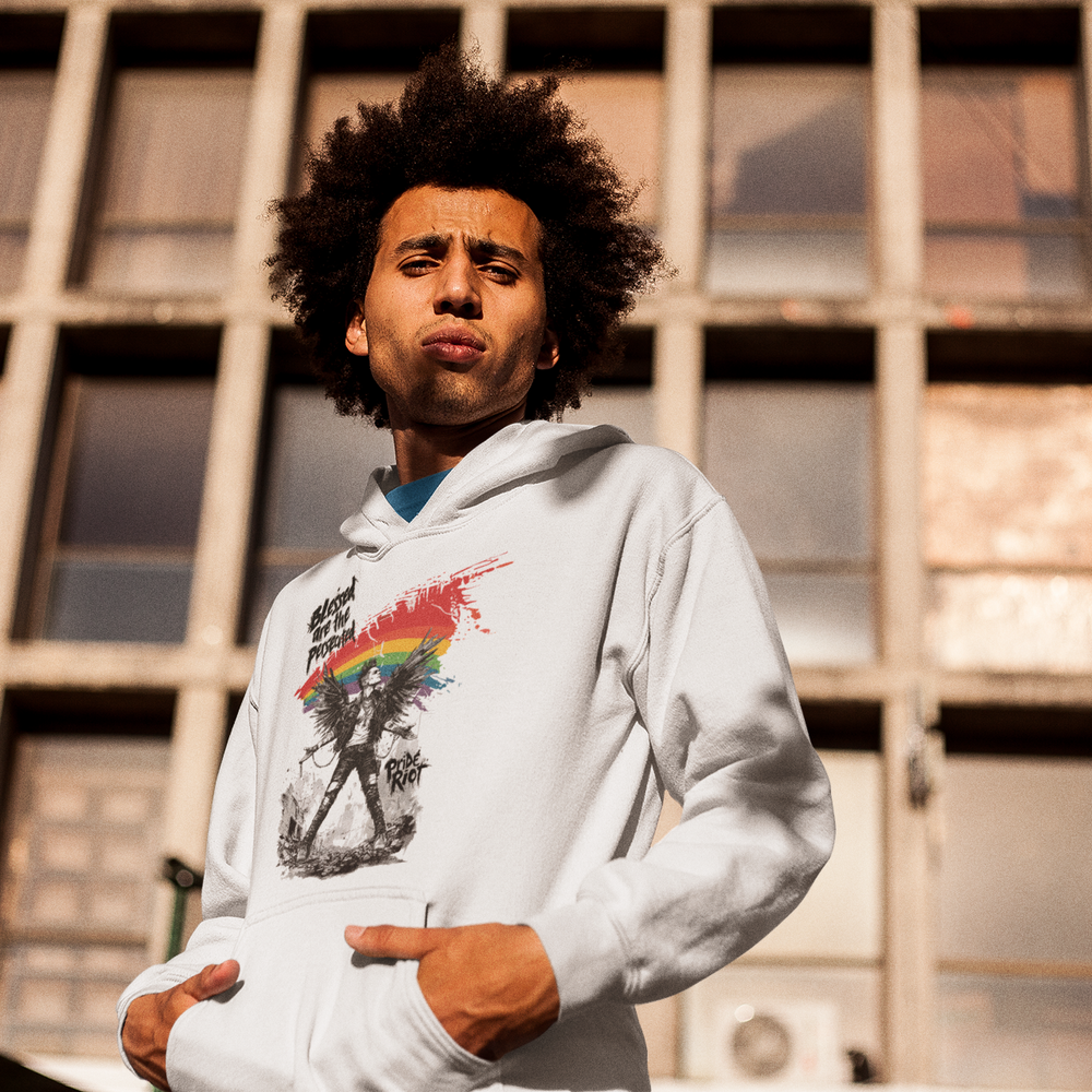 Blessed hoodie in white, worn — a winged punk figure beneath a rainbow brushstroke