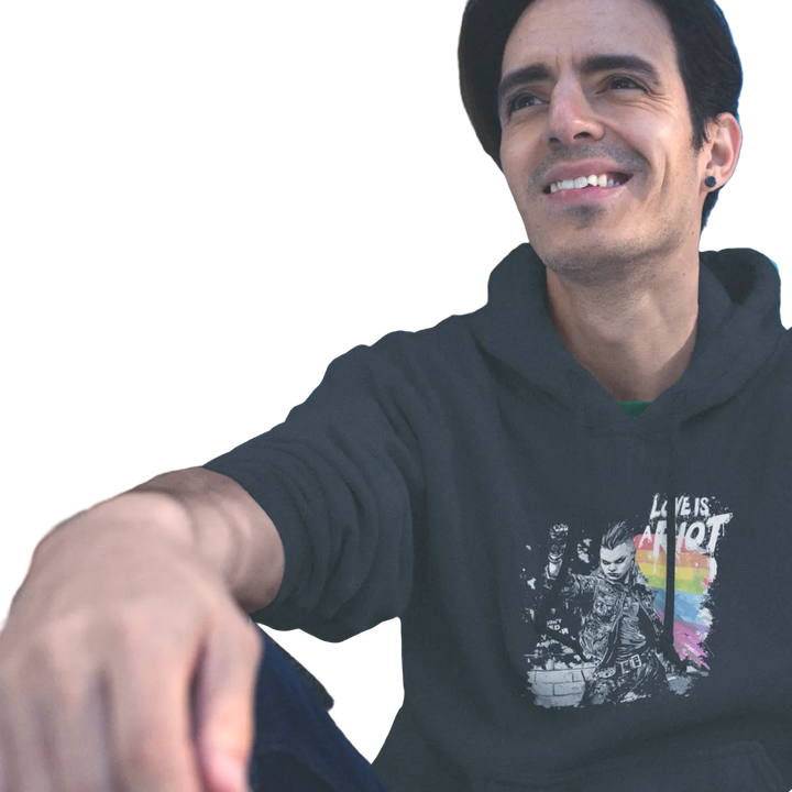 Love is a Riot (Dark) hoodie worn by a model, black — LOVE IS A RIOT lettering over a rainbow paint splash — Pride Riot