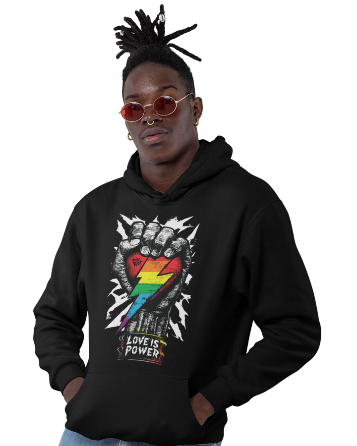 Love is Power (Dark) hoodie worn by a model, black — raised fist with a rainbow lightning bolt and LOVE IS POWER in white — Pride Riot