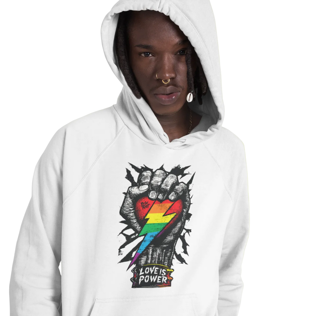 Love is Power (Light) hoodie worn by a model, white — fist breaking through a wall with a rainbow heart and LOVE IS POWER — Pride Riot