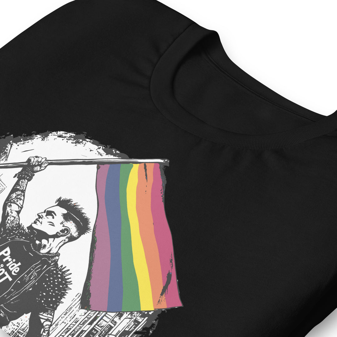 Close-up detail of the rainbow flag print. The red, orange, yellow, green, blue, and purple stripes show a heavy distressed texture and jagged pixelated edges.