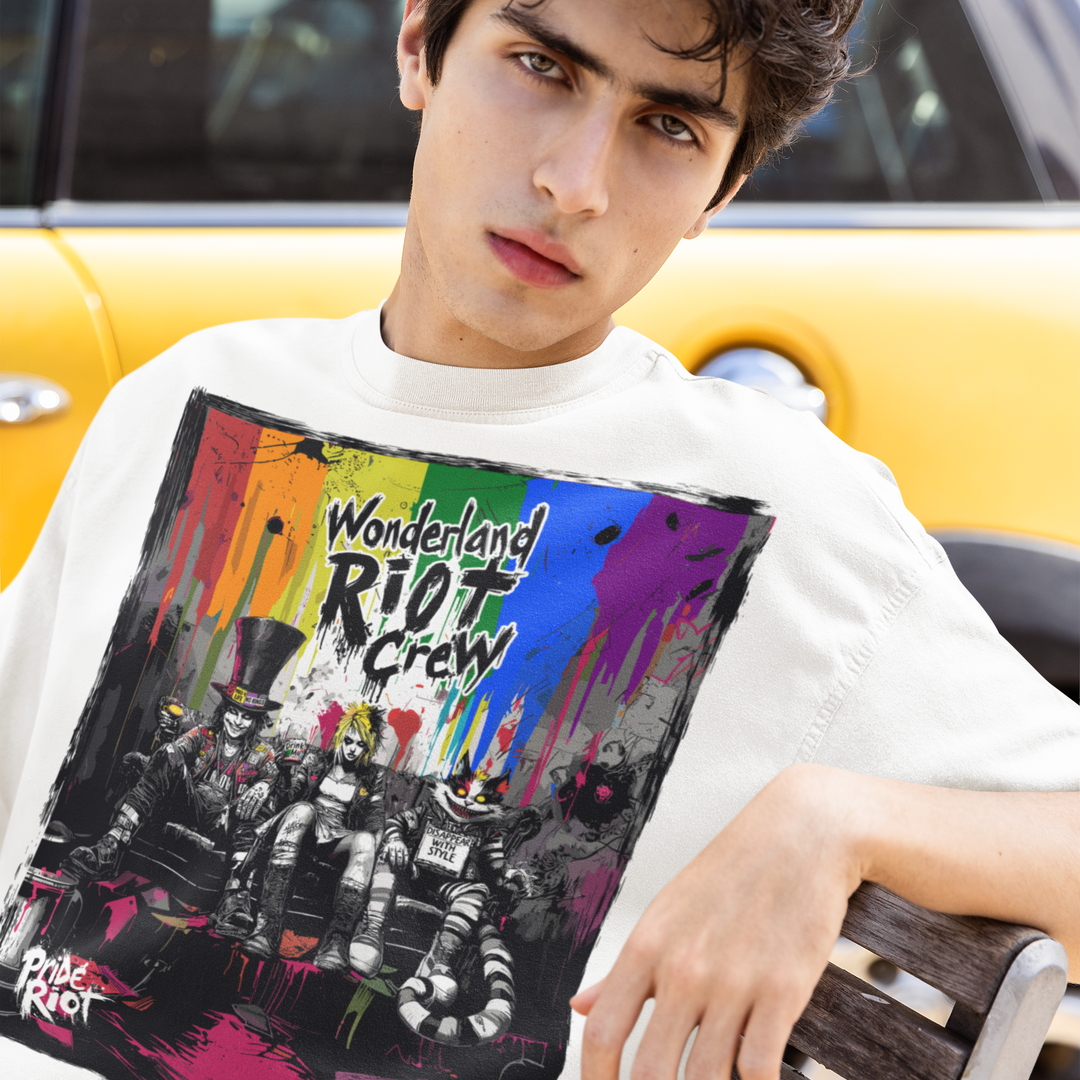 Wonderland Riot Crew tee worn by a model, seated — Pride Riot