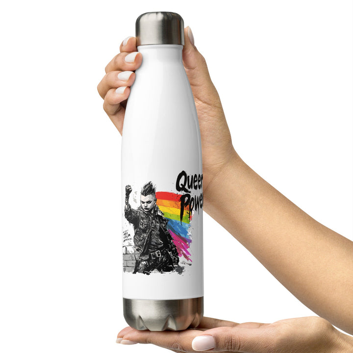 A hand holding a white stainless steel water bottle with a black and rainbow-colored graphic of a person and the text 'Queer Power'. The background is white and the bottle has a glossy finish.