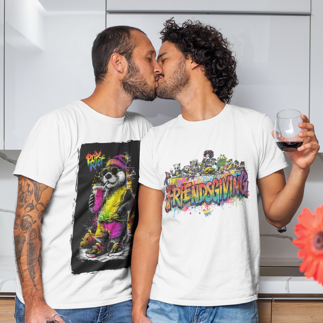 Two men in a kitchen, one holding a glass of wine, wearing colorful t-shirts.