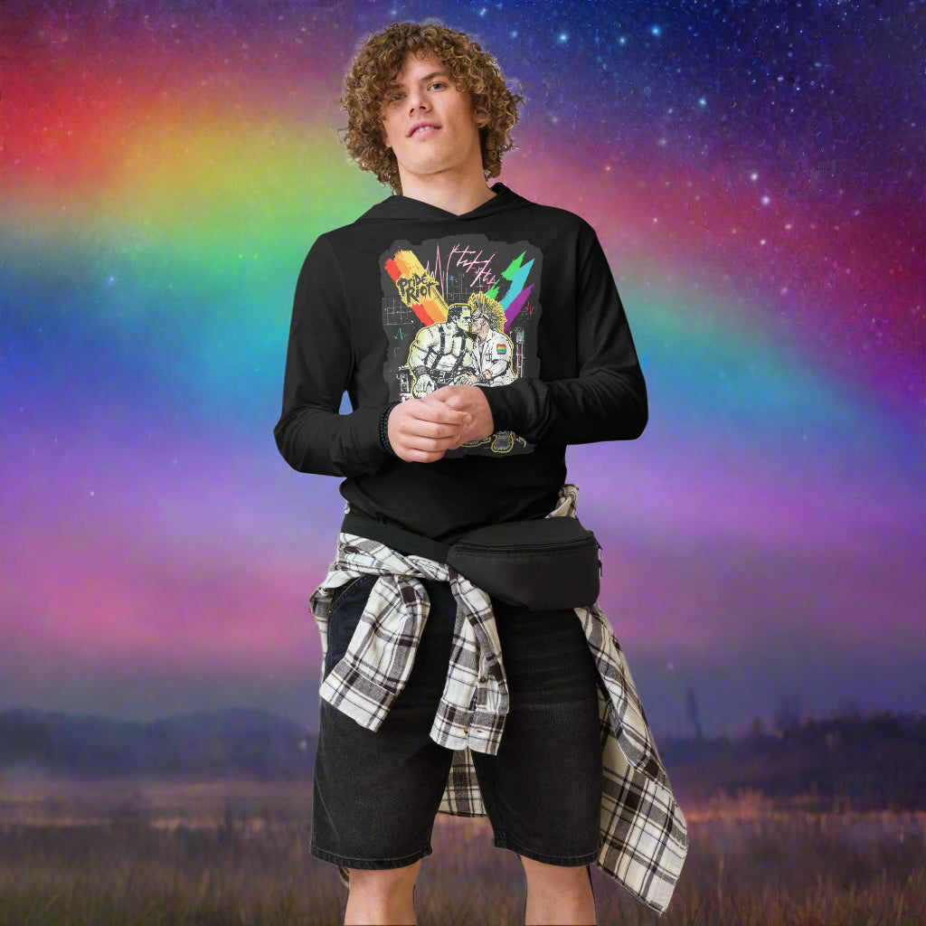 Person wearing a black graphic hoodie and plaid shirt over black shorts 