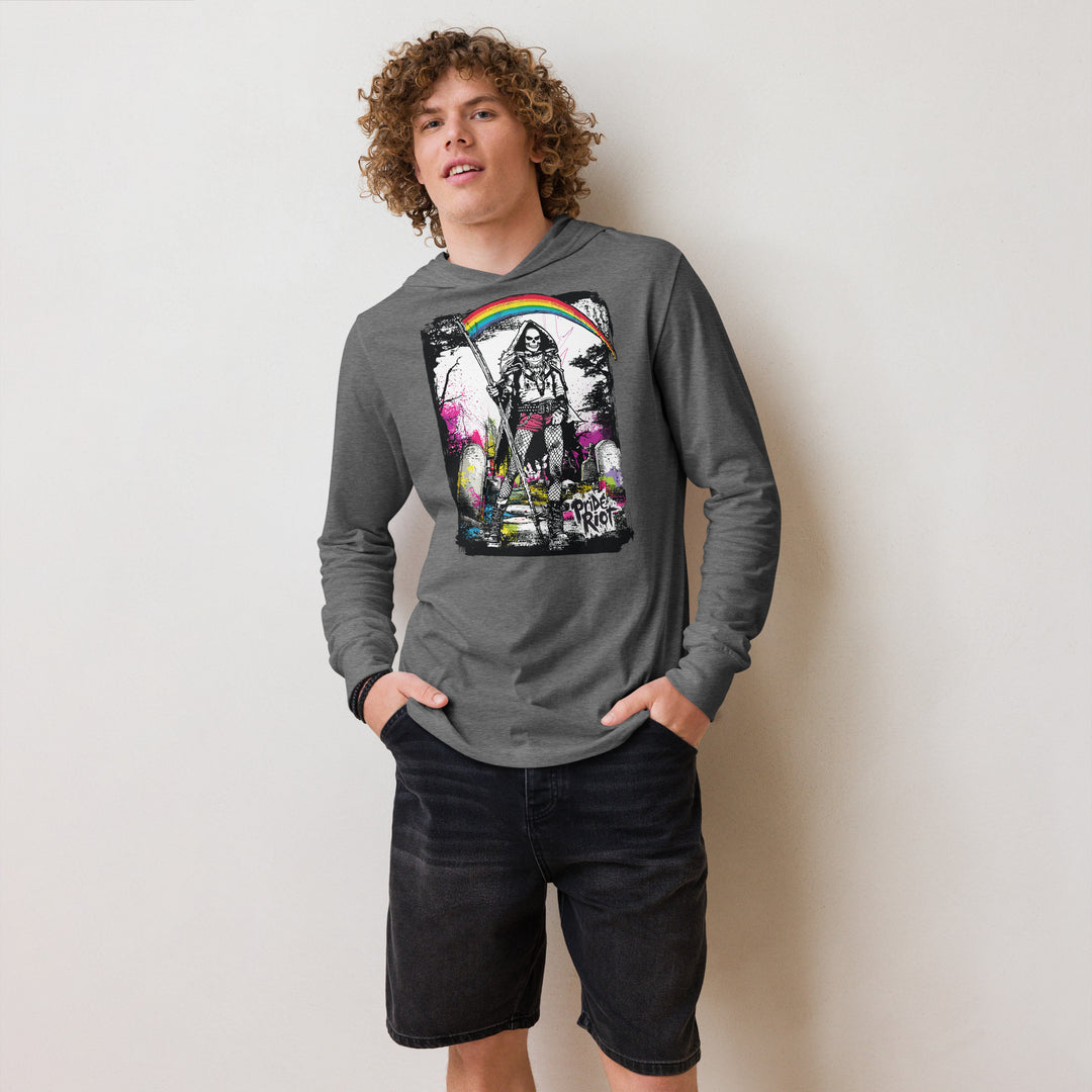 Person wearing a gray long-sleeve shirt with a colorful graphic design on a plain background